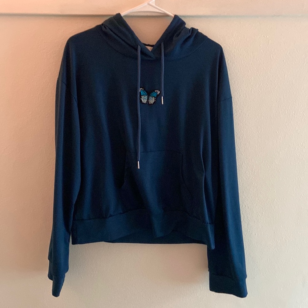 Navy hoodie with butterfly.